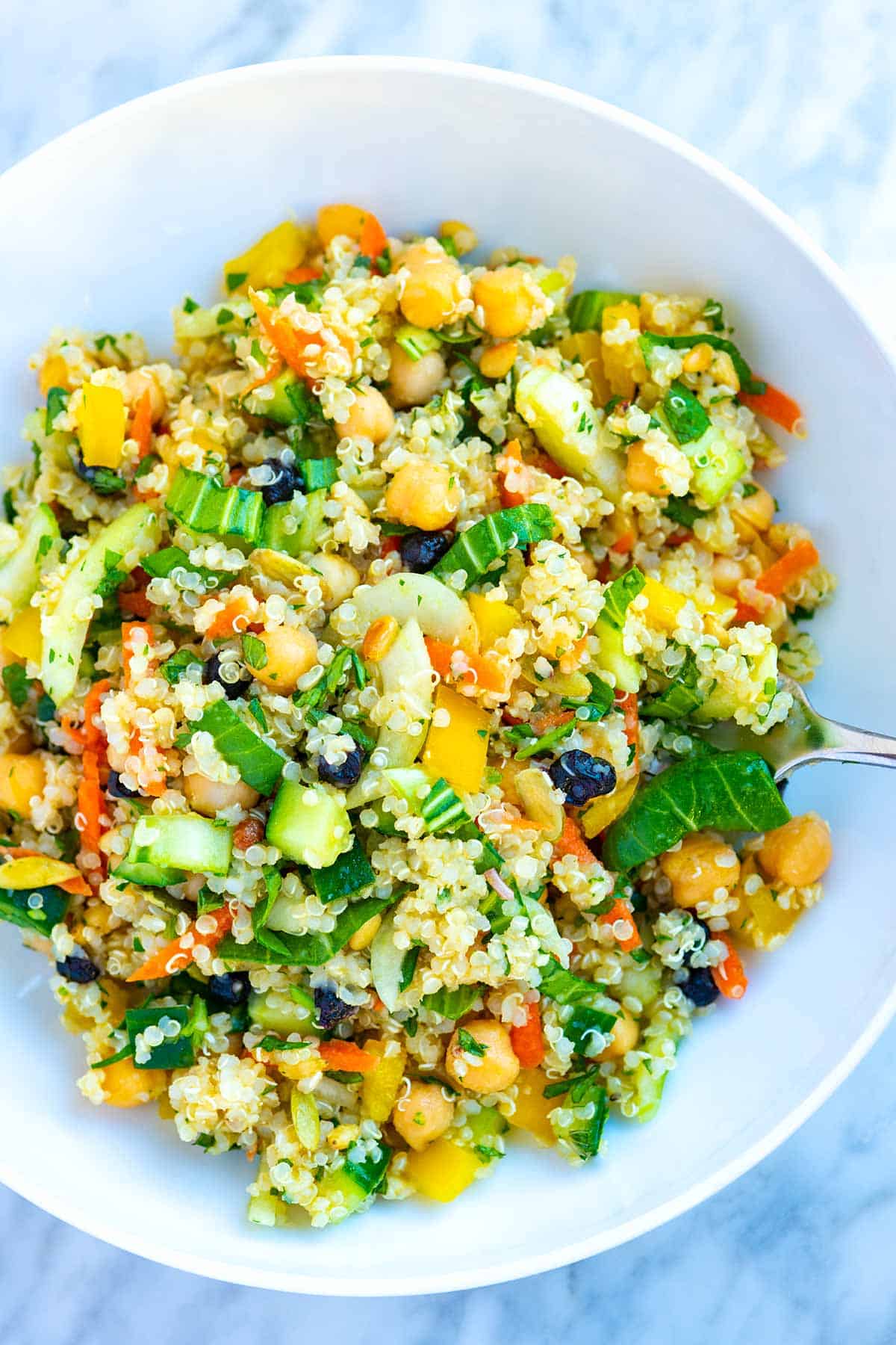 Healthy quinoa salad with veggies, dried fruits, and chickpeas