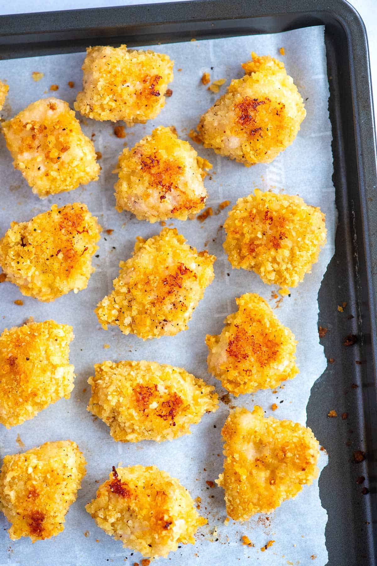 Baked chicken nuggets on a baking sheet