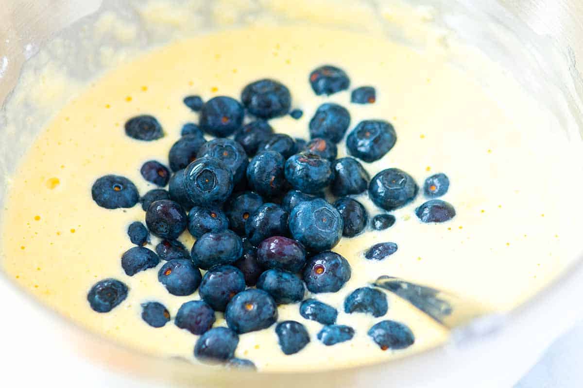 Stirring blueberries into pancake batter