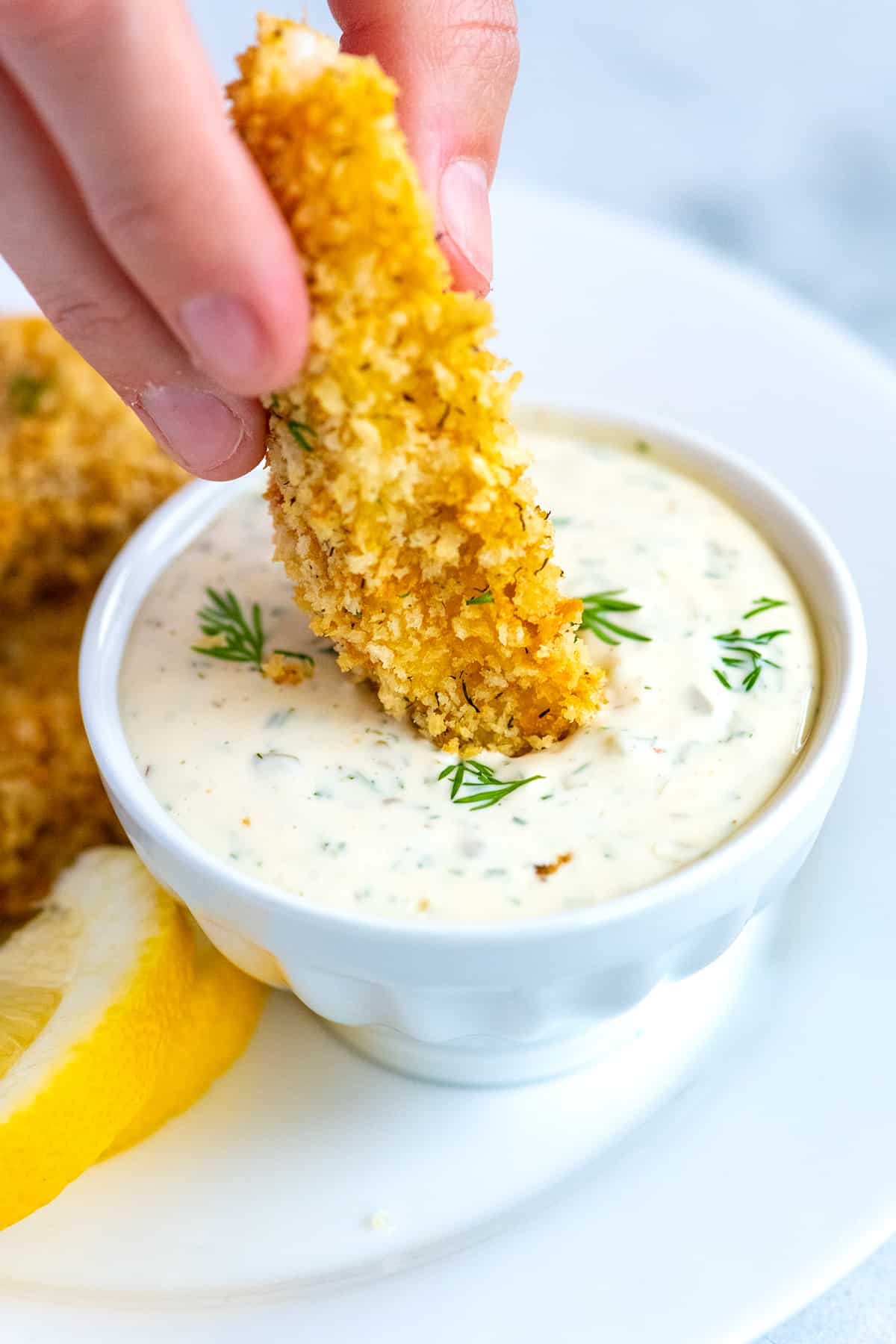 Dipping a fish stick into homemade tartar sauce