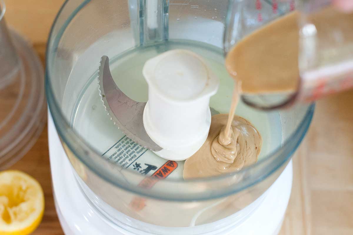 For the creamiest, smoothest hummus, we add tahini and lemon juice first to our food processor.