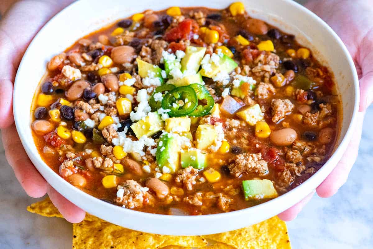 I love this easy taco soup! This easy weeknight taco soup recipe makes use uses of pantry staples and you can cook it a variety of ways including on the stovetop, in a slow cooker, and in a pressure cooker.