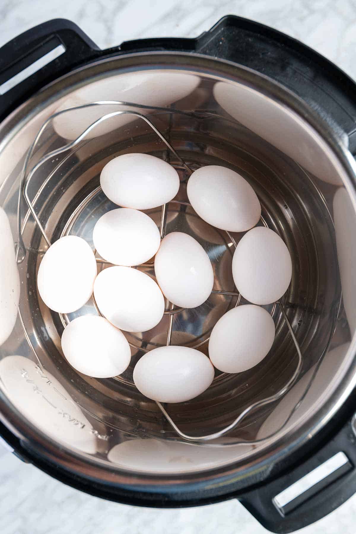 Instant Pot hard-boiled eggs cut in half, ready for salads, deviled eggs, and more