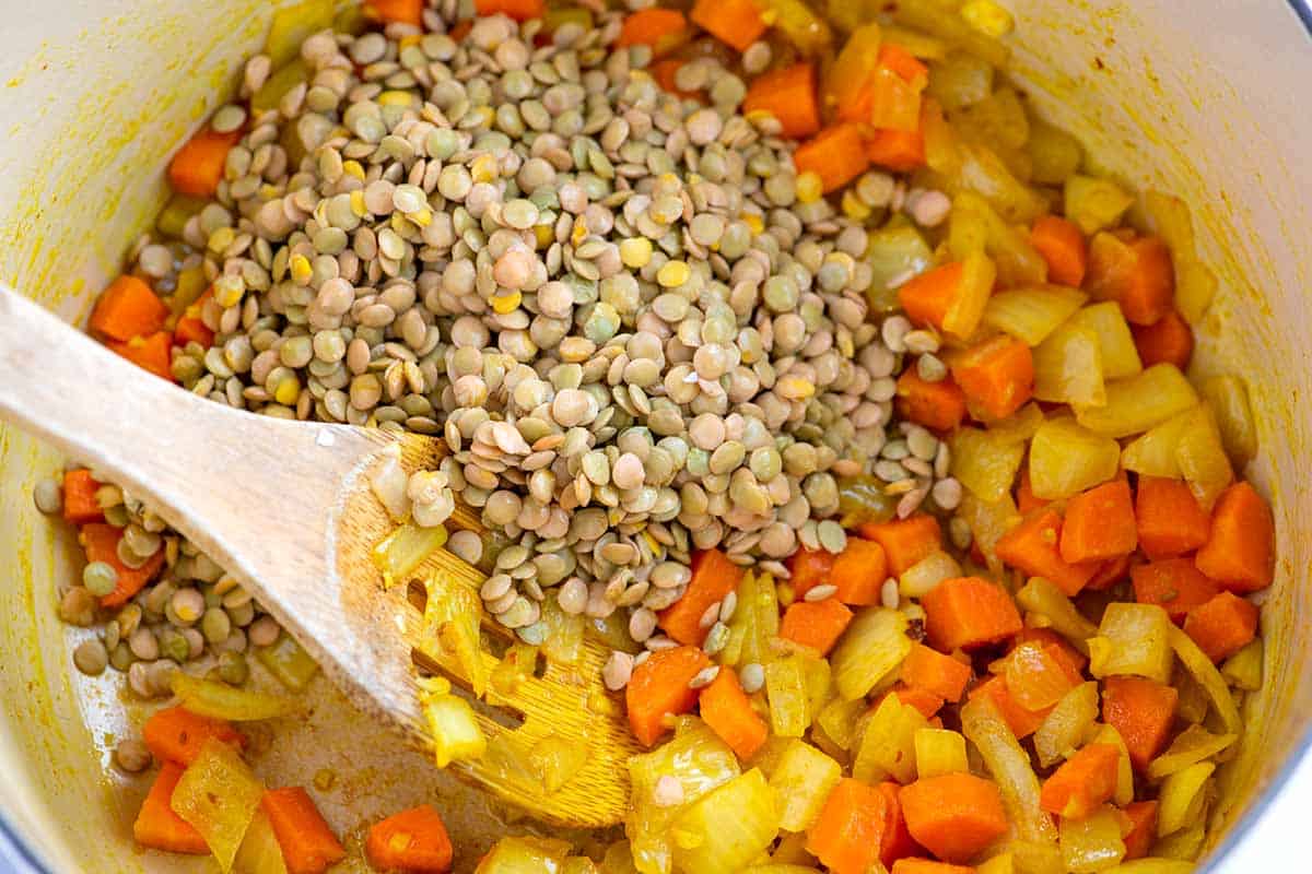 Uncooked lentils with carrots, onions and turmeric