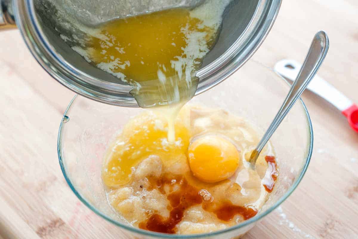 Mixing the wet ingredients for banana chocolate chip muffins