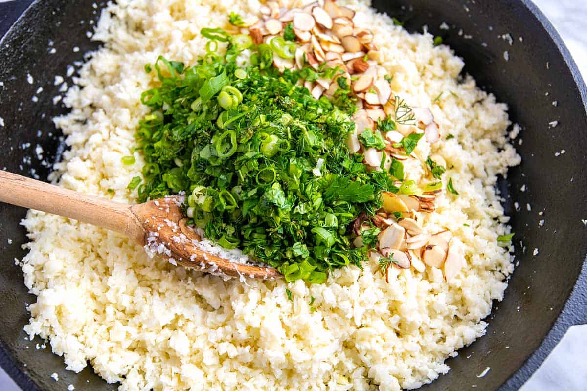 Add herbs and toasted almonds to the cauliflower rice