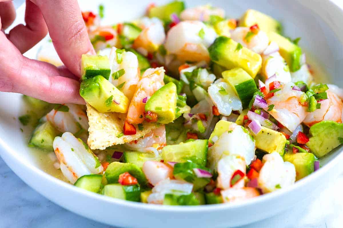 How to make fresh, healthy, and delicious shrimp ceviche! This shrimp ceviche is made with limes, lemon, red onion, cucumber, chile peppers, cilantro, and avocado.