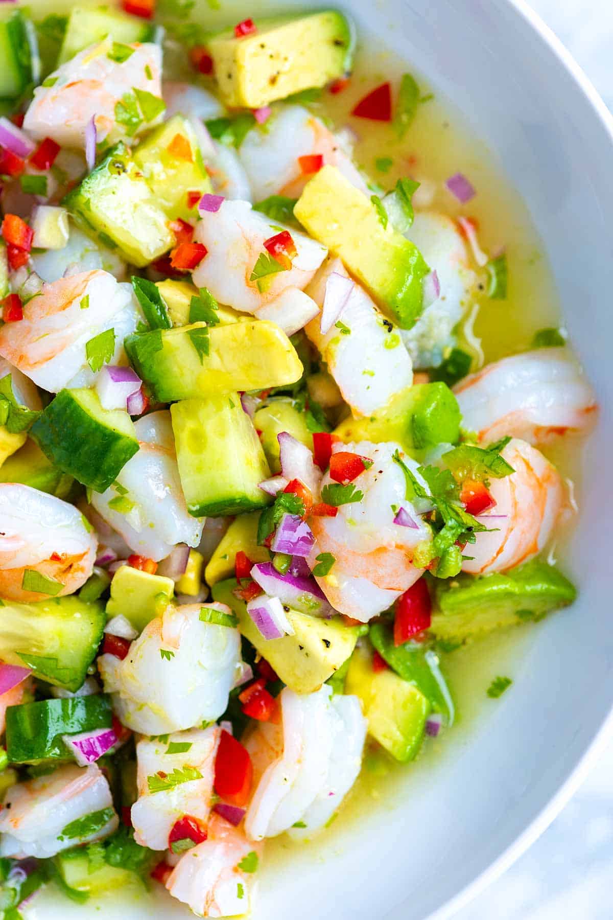 How to make fresh, healthy, and delicious shrimp ceviche! This shrimp ceviche is made with limes, lemon, red onion, cucumber, chile peppers, cilantro, and avocado. I love it served as an appetizer or for a light meal. 