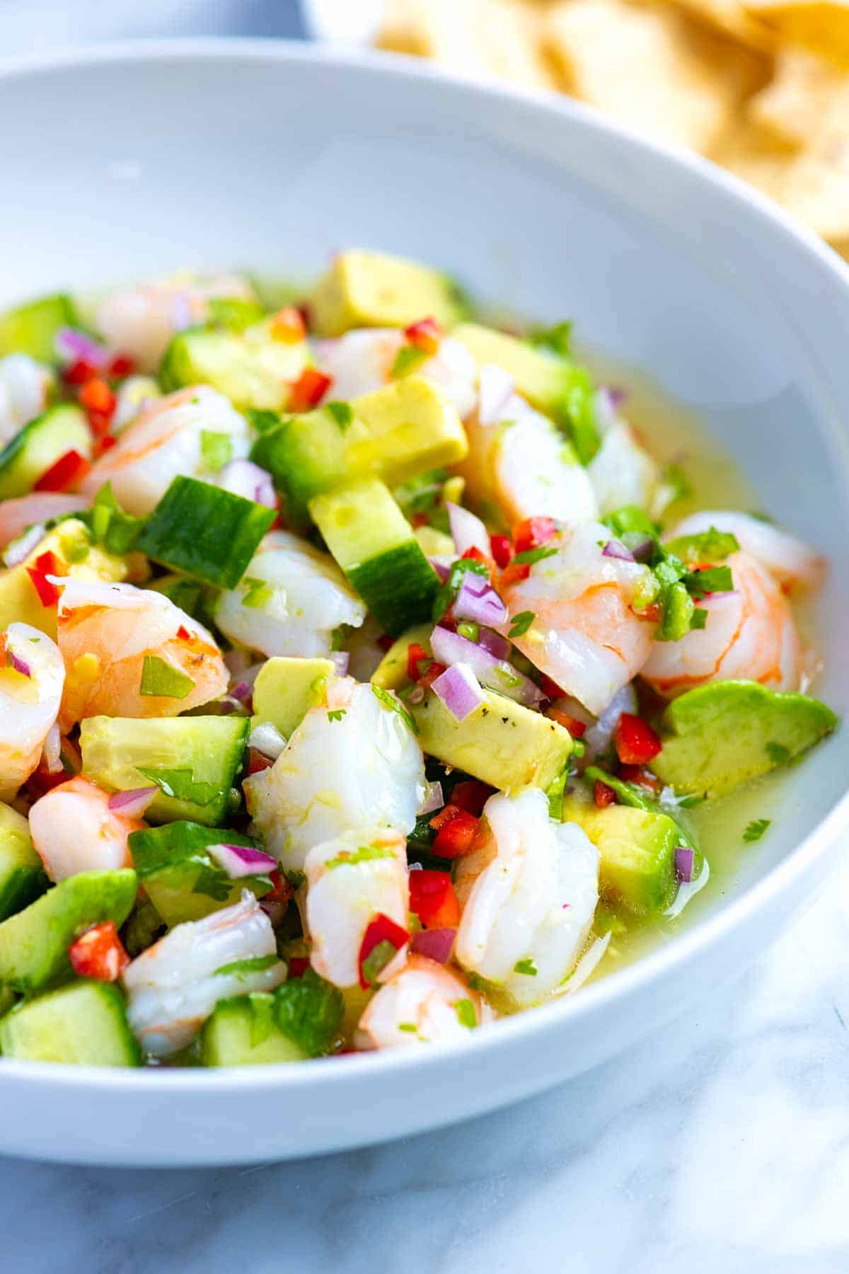 How to make fresh, healthy, and delicious shrimp ceviche! This shrimp ceviche is made with limes, lemon, red onion, cucumber, chile peppers, cilantro, and avocado. I love it served as an appetizer or for a light meal. 