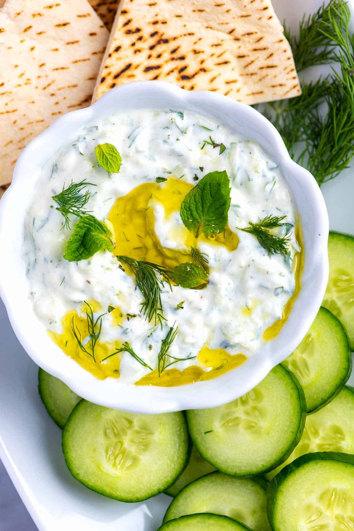 Tzatziki is a creamy, delicious, and simple sauce made with cucumber, yogurt, and fresh herbs.