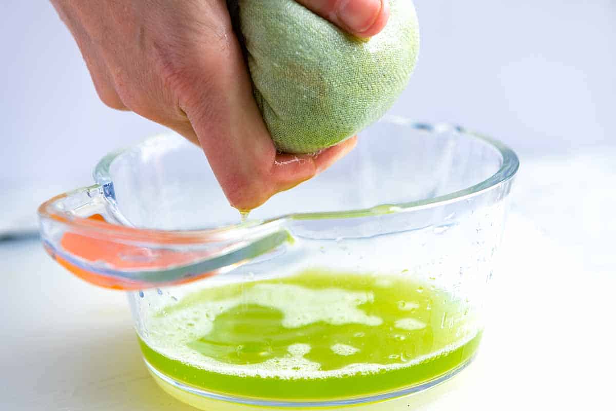 Showing how to make the best tzatziki by wringing excess water out of the grated cucumber