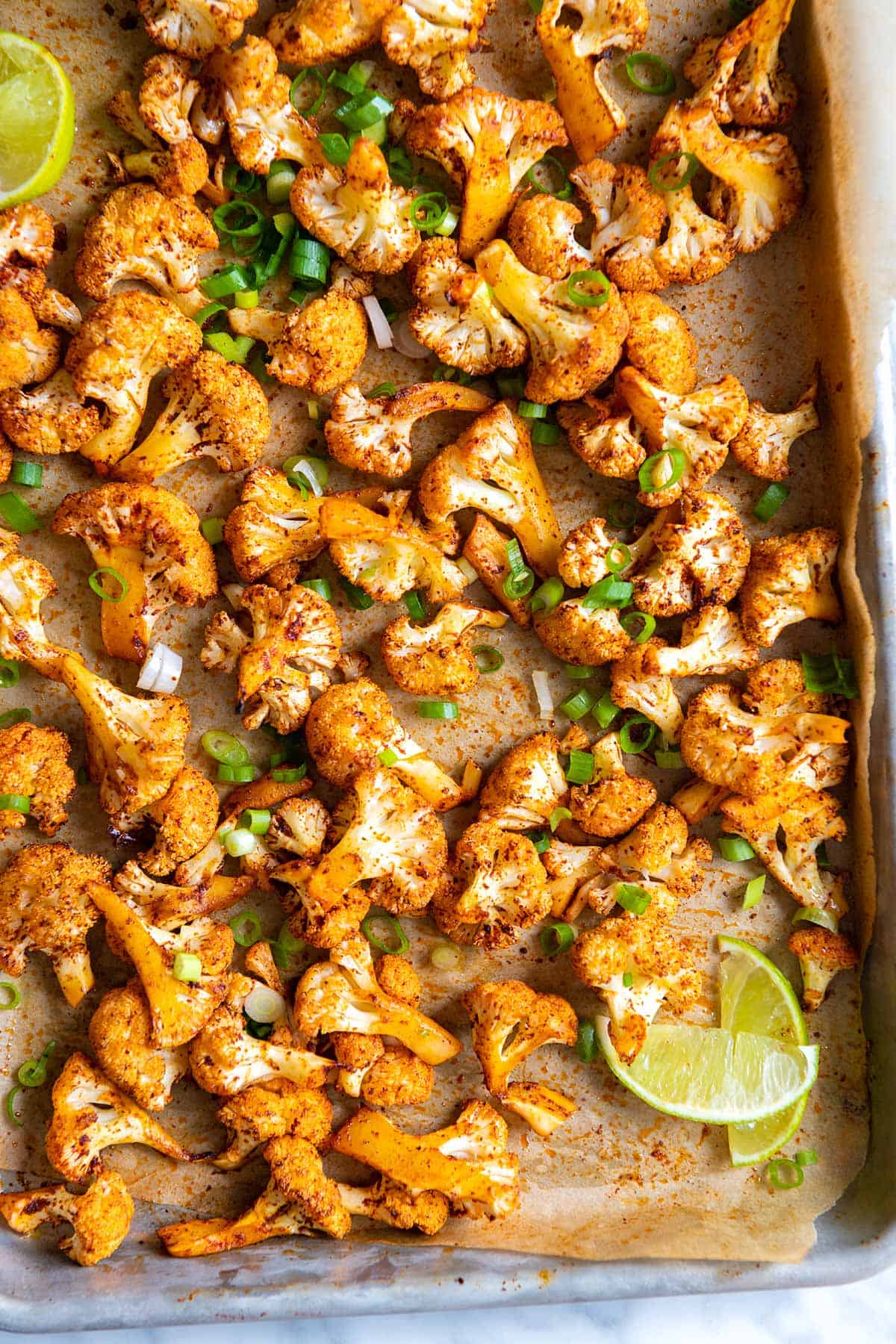 Spicy roasted cauliflower with spices, fresh lime juice and scallions.