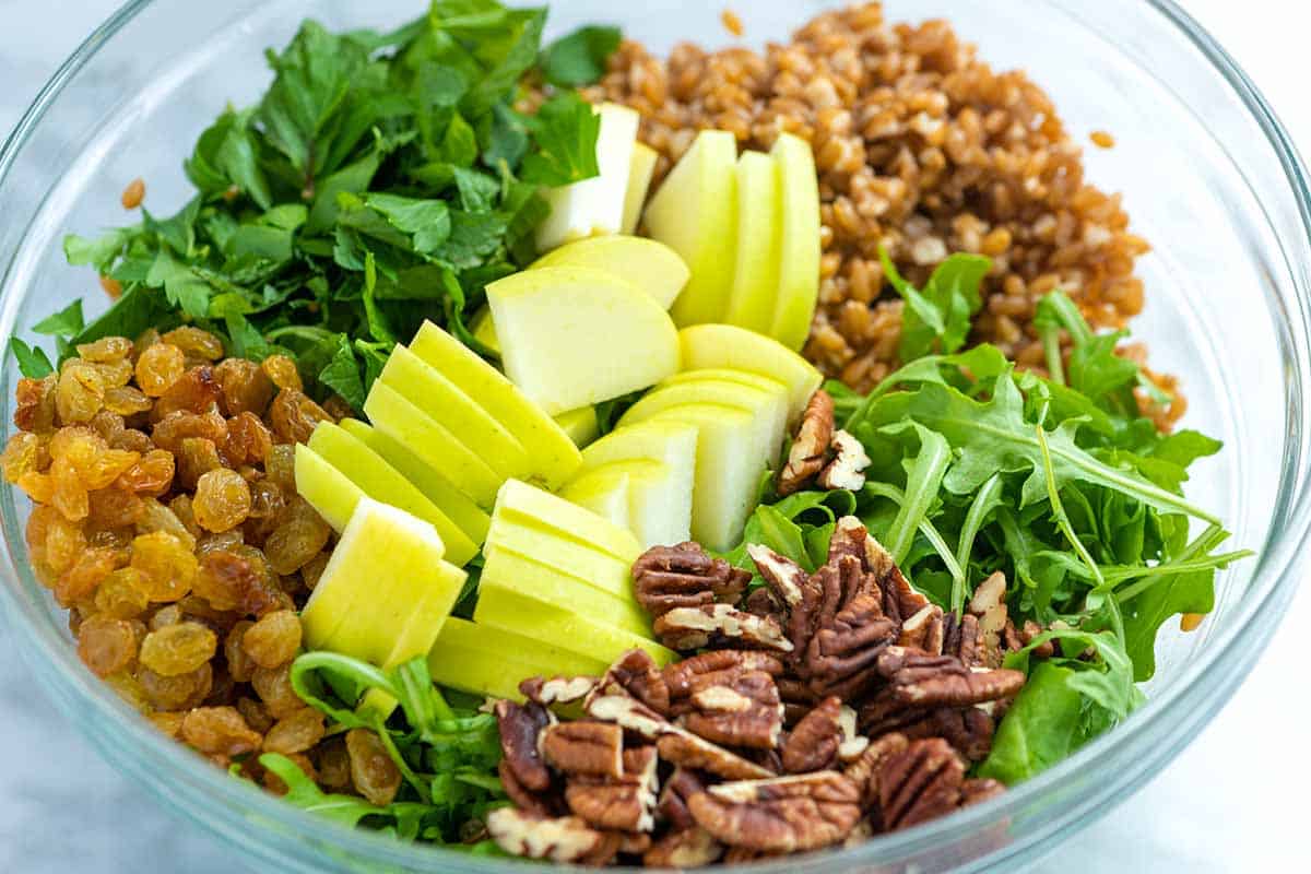 How to Make Farro Salad: Ingredients in a bowl ready to be tossed