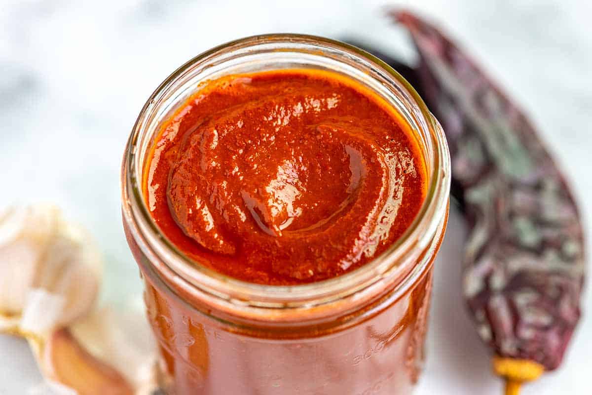 Jar of homemade red enchilada sauce made with chilies