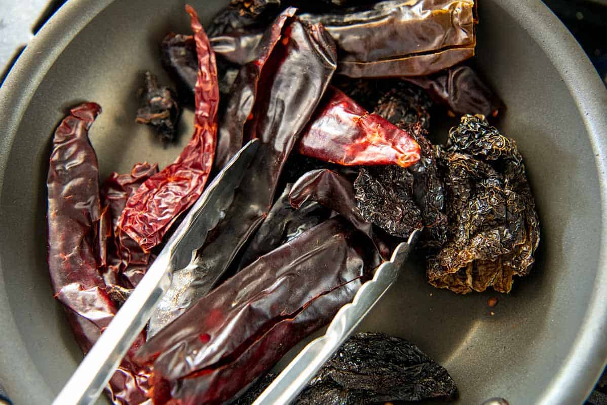 Lightly toasting chili peppers for enchilada sauce