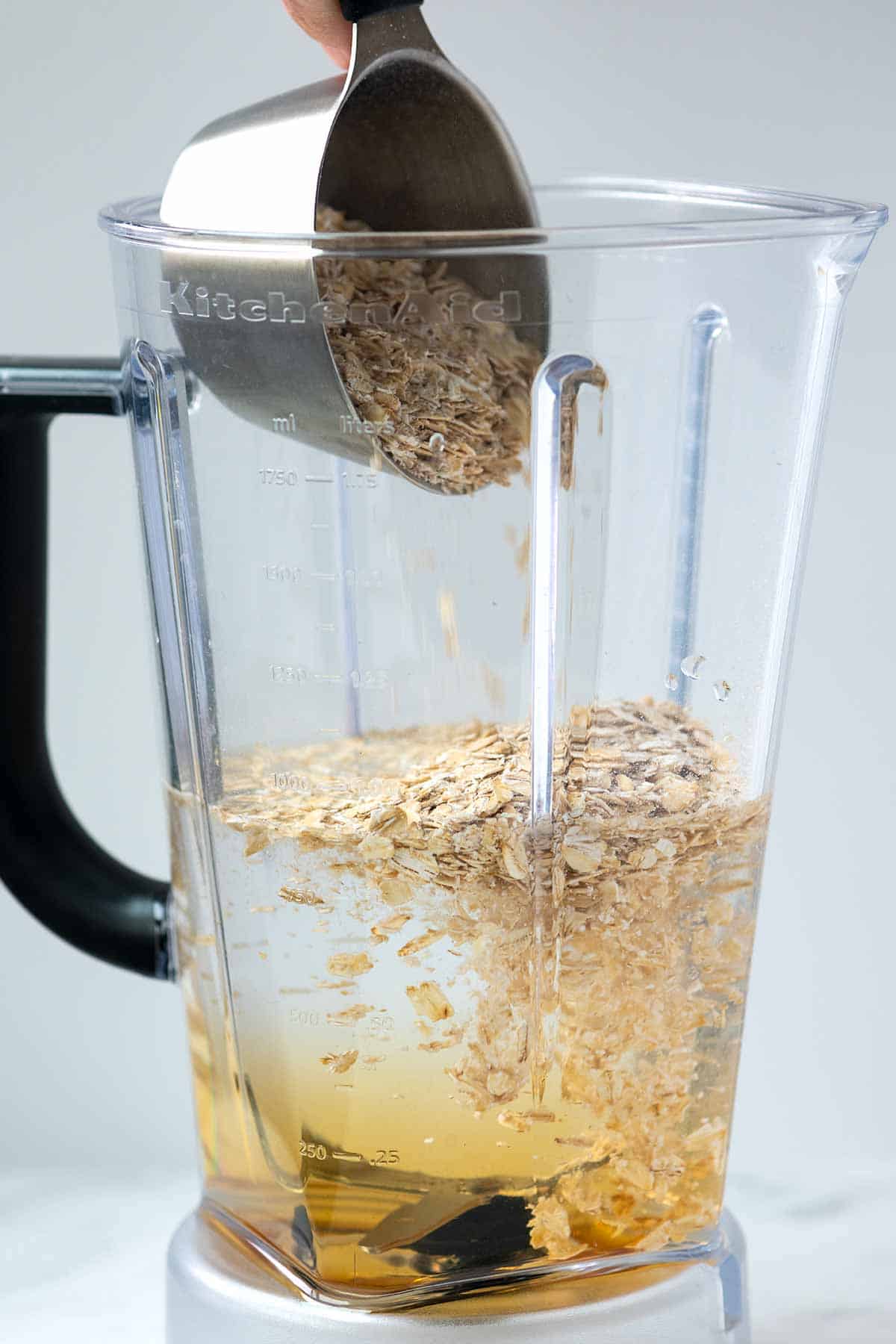 Cold water, maple syrup, a pinch of salt, and rolled oats in a blender