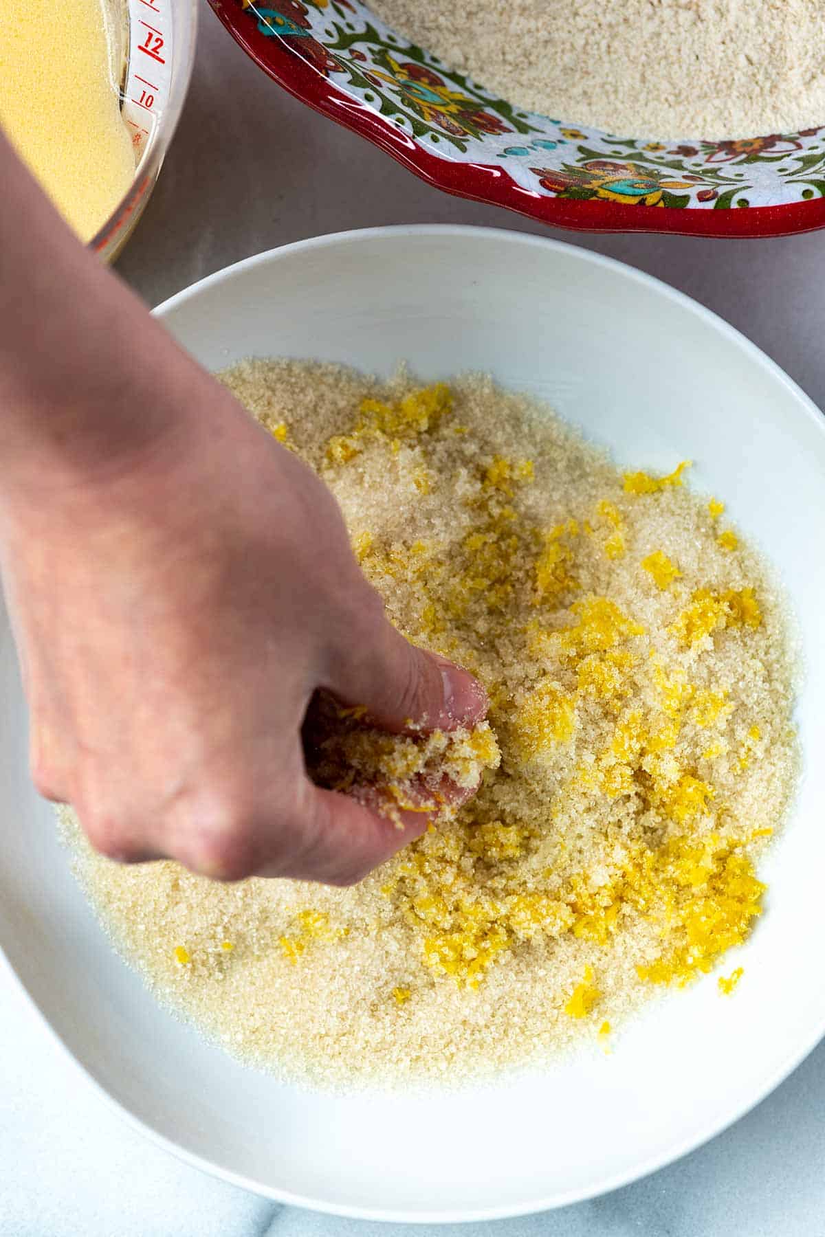 Making lemon sugar for the muffins by rubbing lemon zest into the sugar