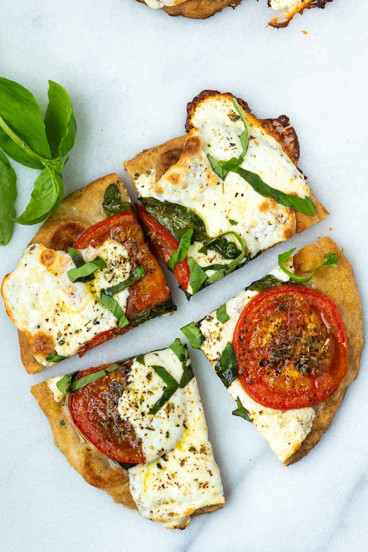 Flatbread pizza with tomatoes, mozzarella and basil