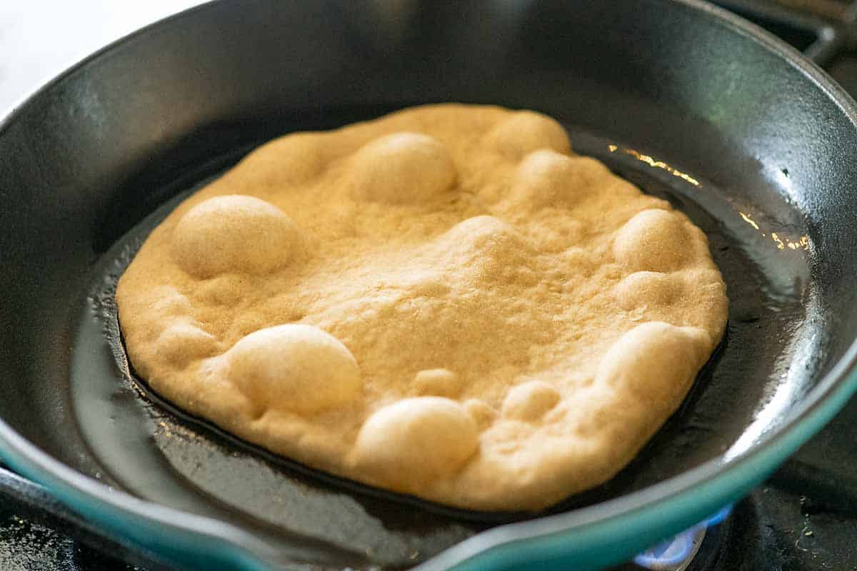 Cooking homemade flatbread in a skillet