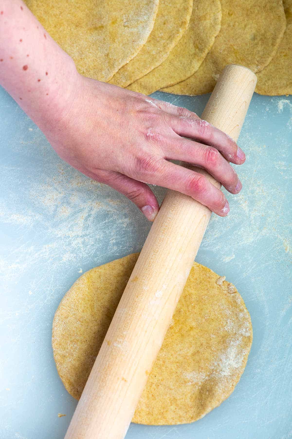 Rolling out the flatbread dough into thin discs