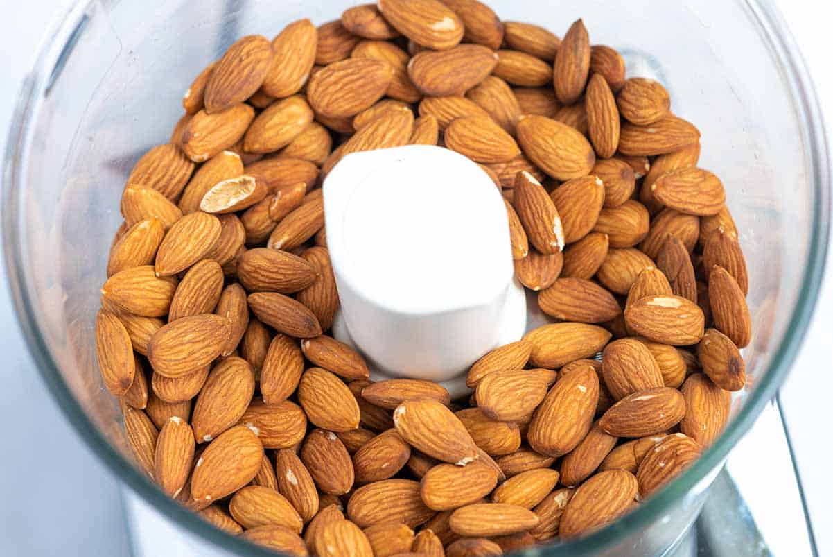 Whole toasted almonds in a food processor