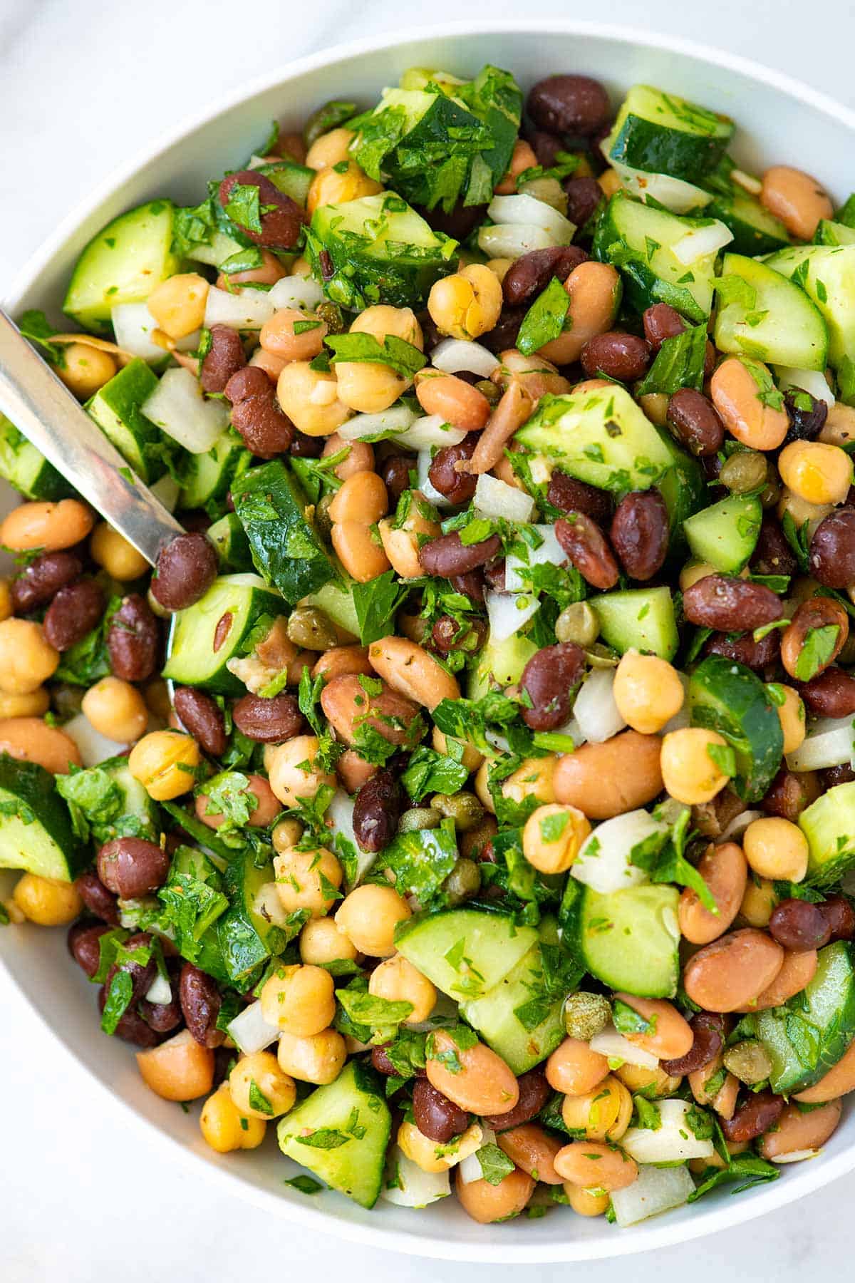 Salad with beans, cucumbers, onion, and parsley