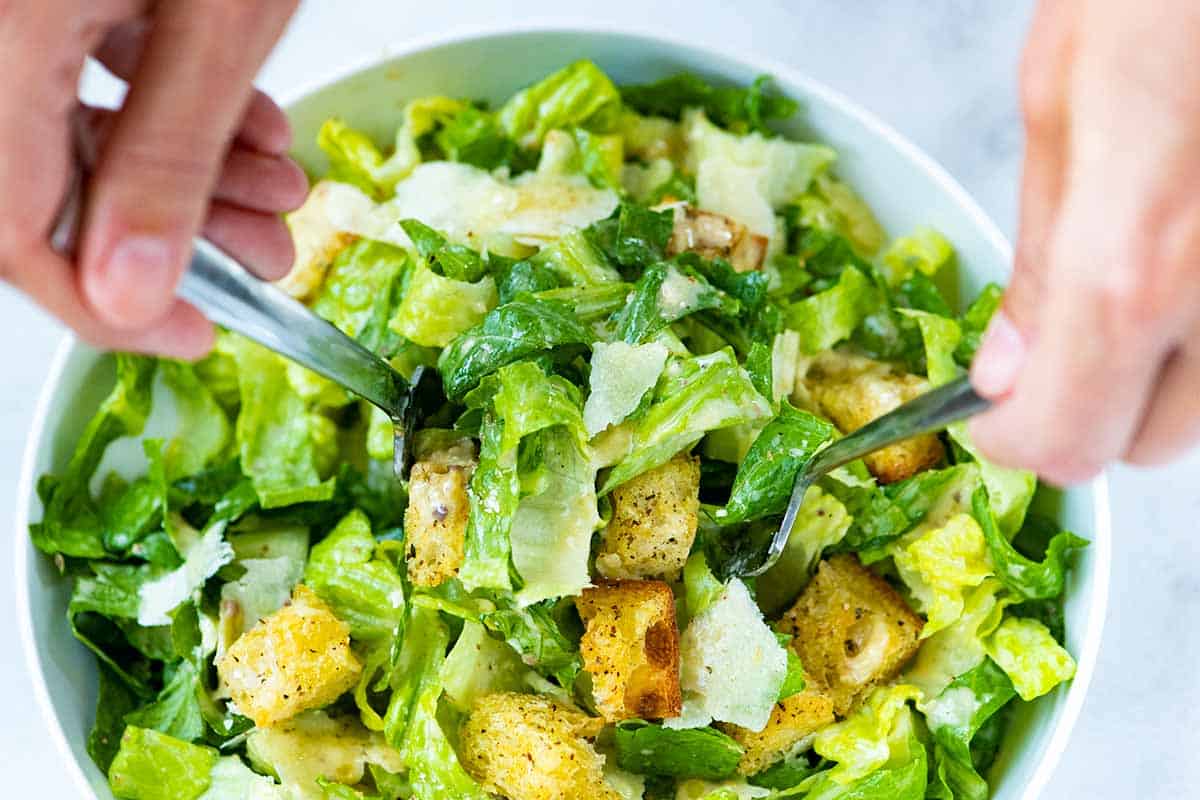 Homemade Caesar Salad ready to eat with homemade dressing, croutons and parmesan