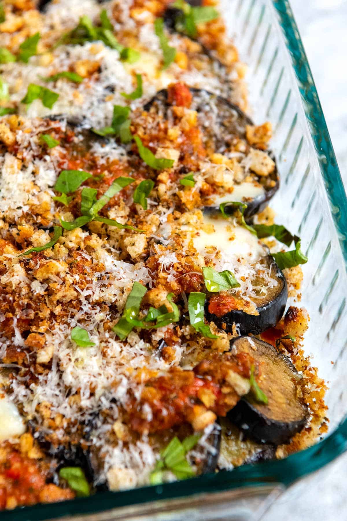 Eggplant parmesan with roasted eggplant slices, parmesan cheese, mozzarella and breadcrumbs on top.