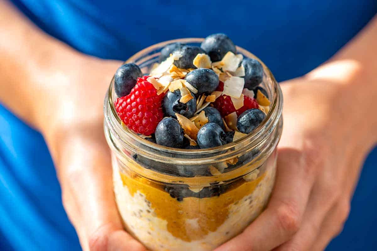 Overnight Oats with peanut butter, berries and toasted coconut.