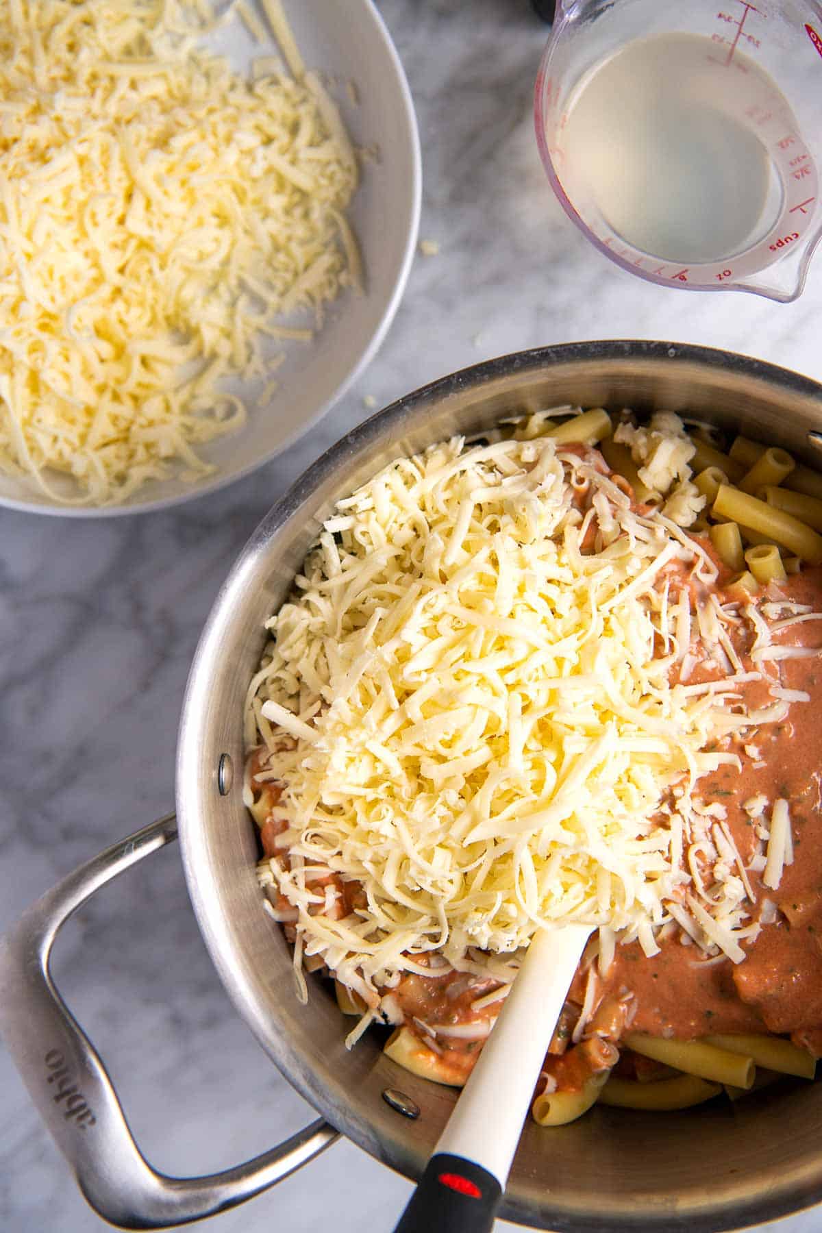 How to Make Baked Ziti: Stirring ziti into the tomato sauce with cheese