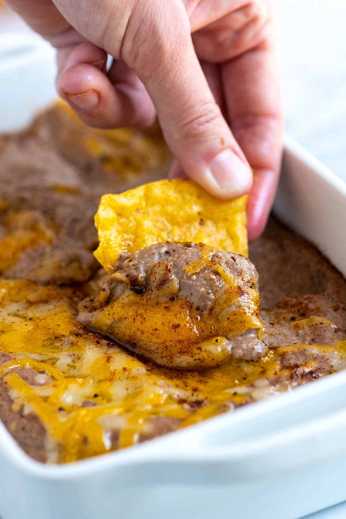 Scooping Up Creamy Black Bean Dip with a Tortilla Chip