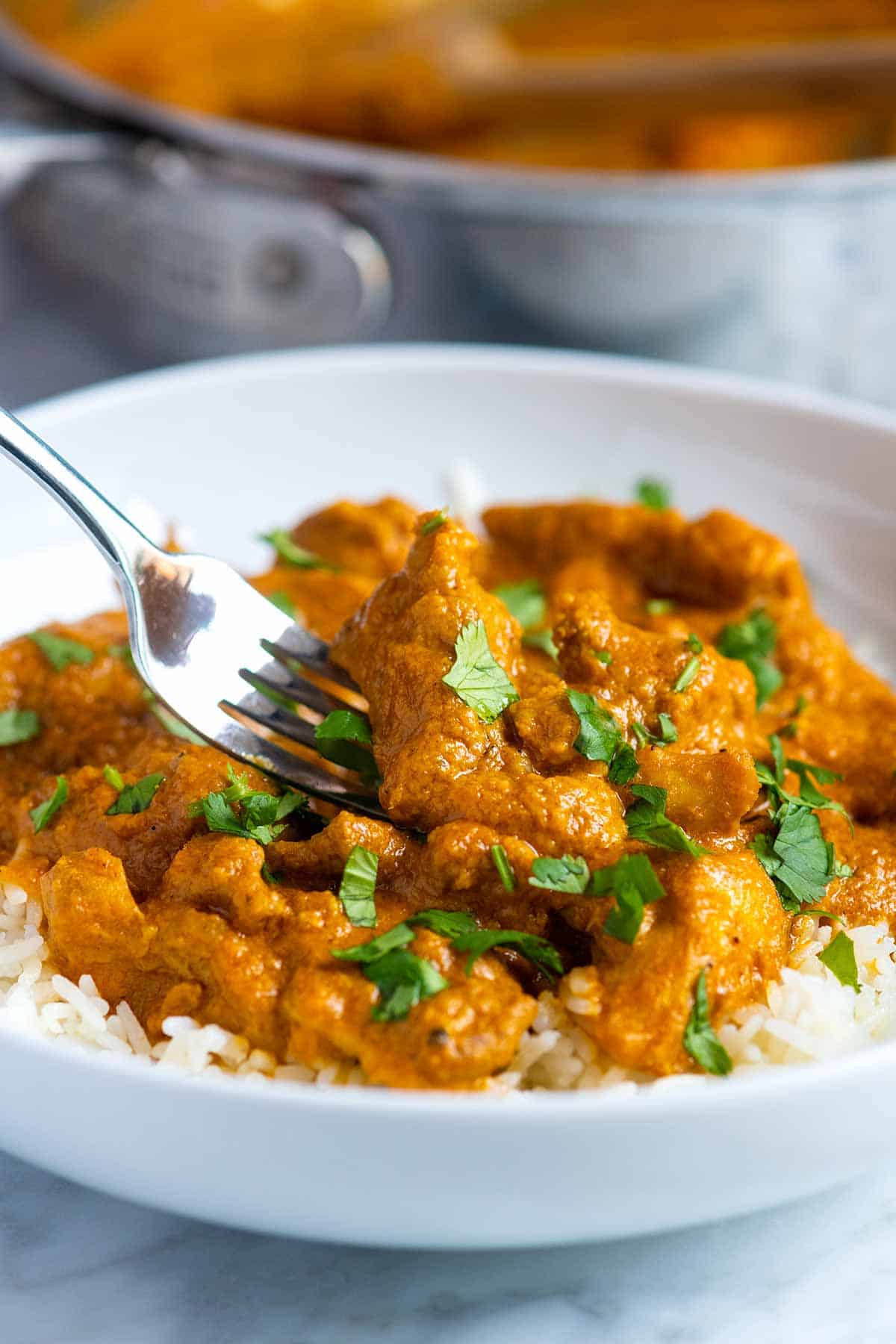 A bowl of Basmati rice topped with chicken curry