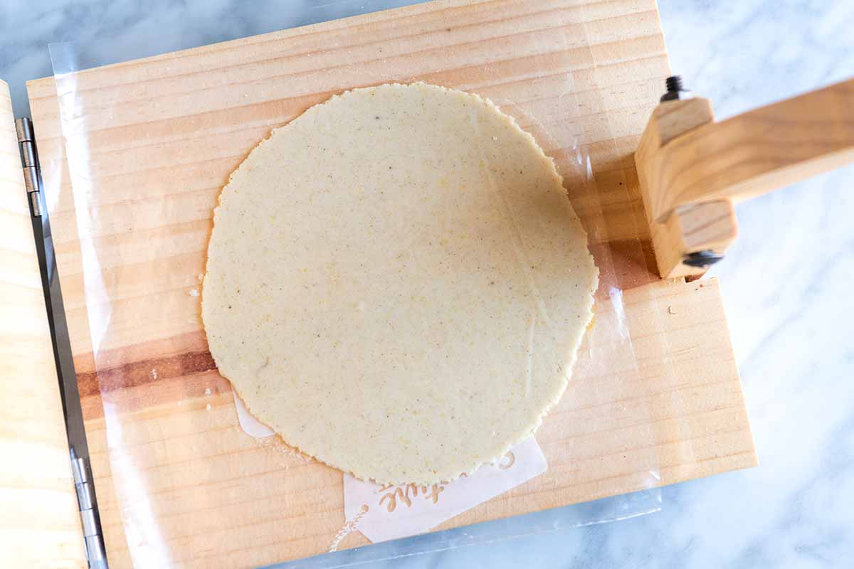 Pressing corn tortillas using a tortilla press, step 3 (open press).