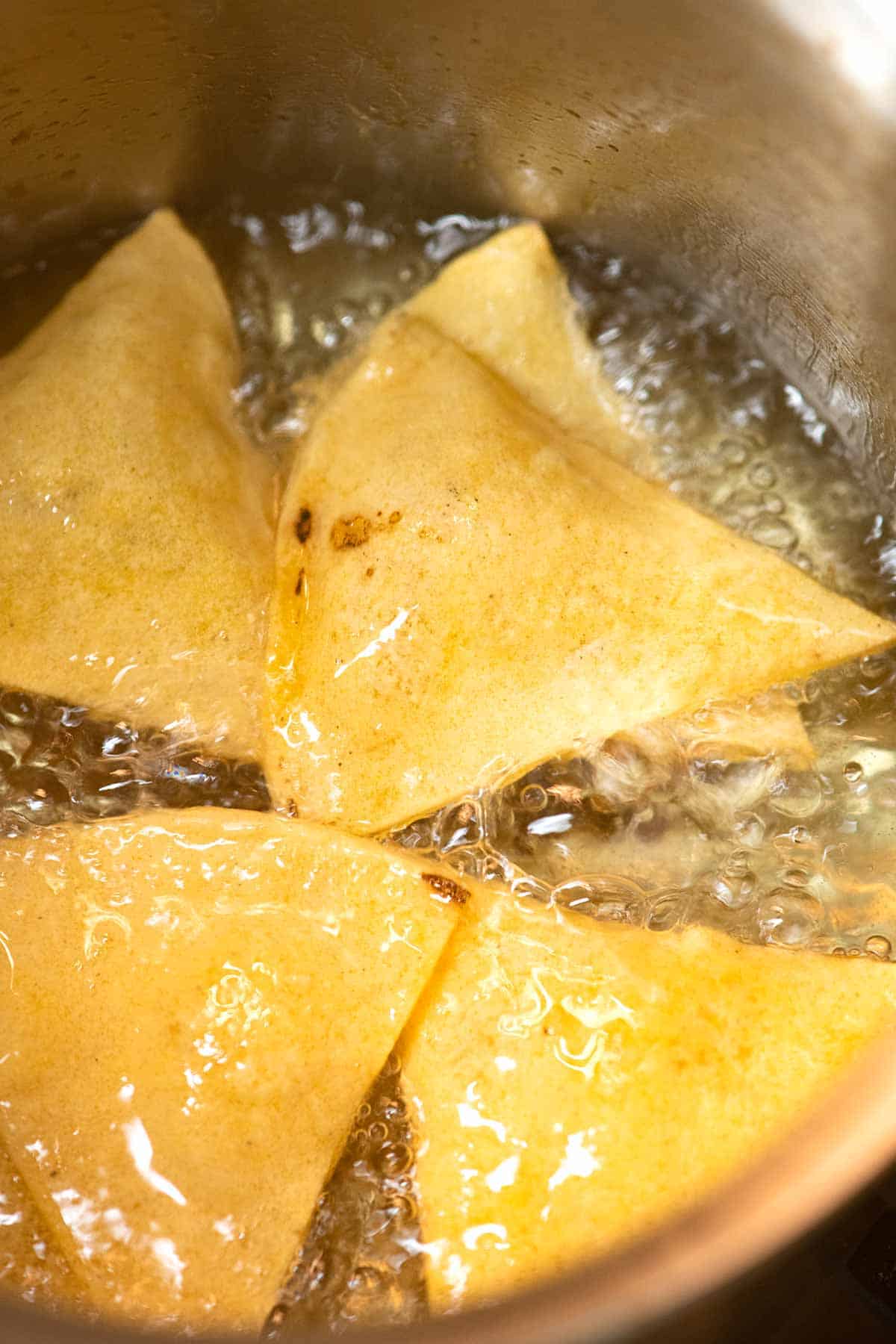 Tortilla chips frying in oil