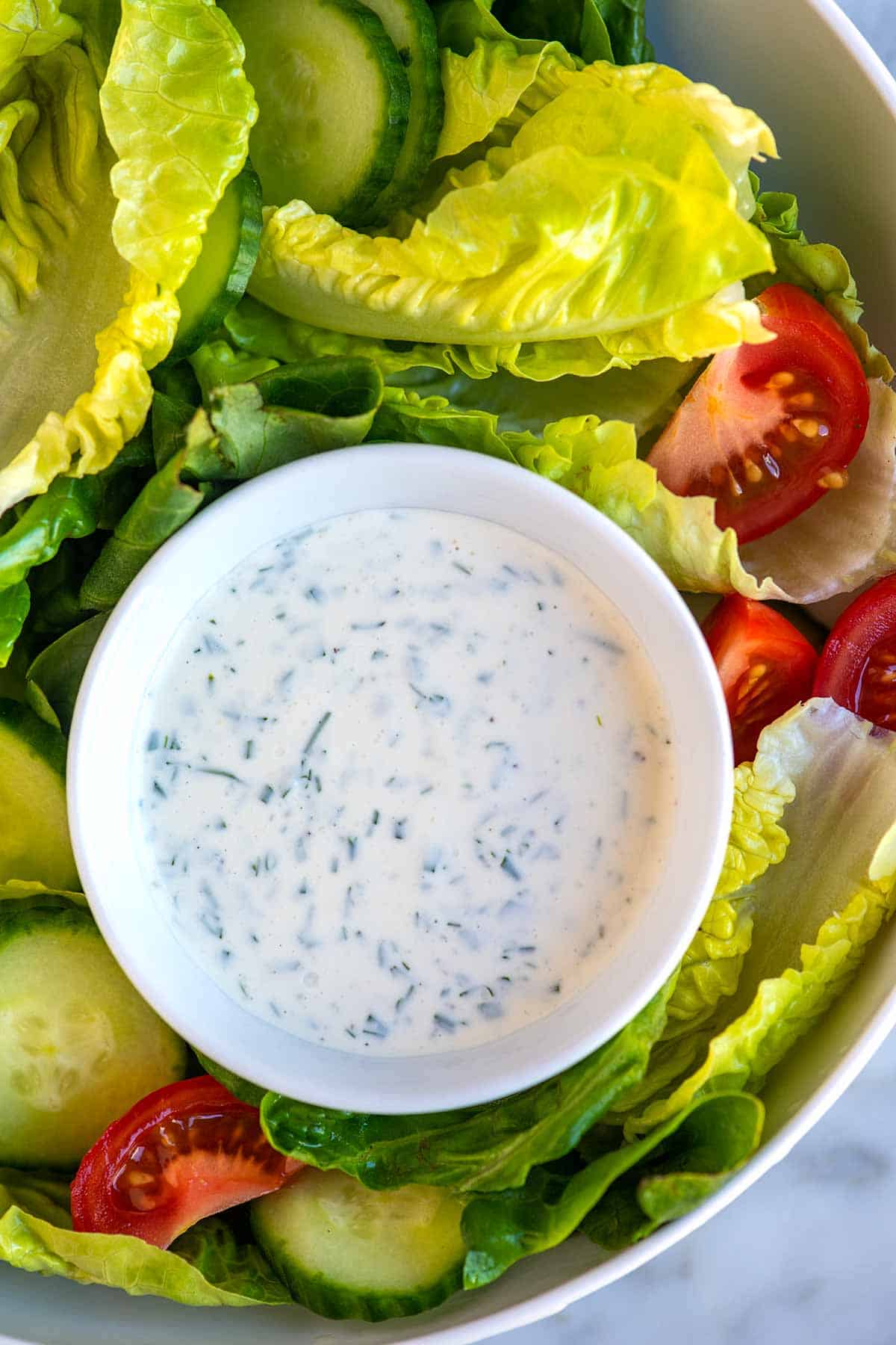 Ranch dressing made from scratch served with lettuce, tomatoes and cucumber