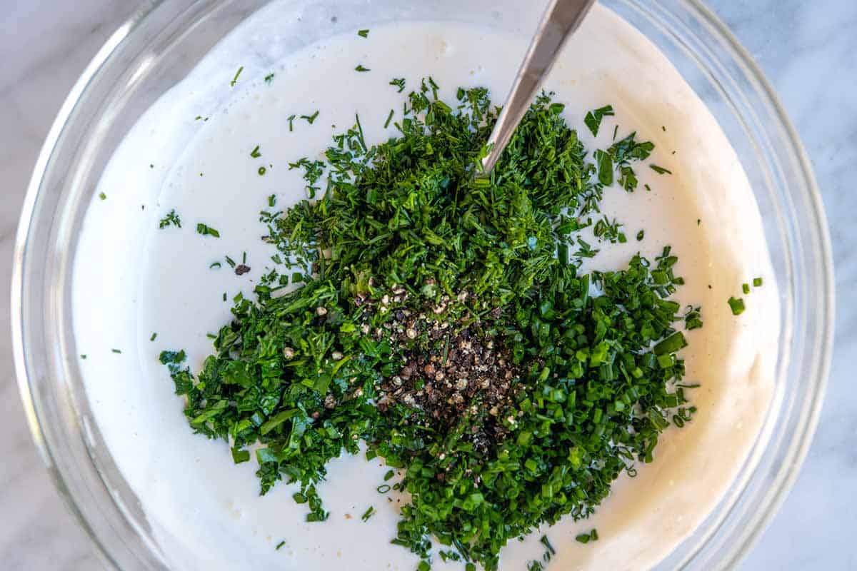 How to Make Homemade Ranch Dressing - mixing ranch dressing ingredients with fresh herbs
