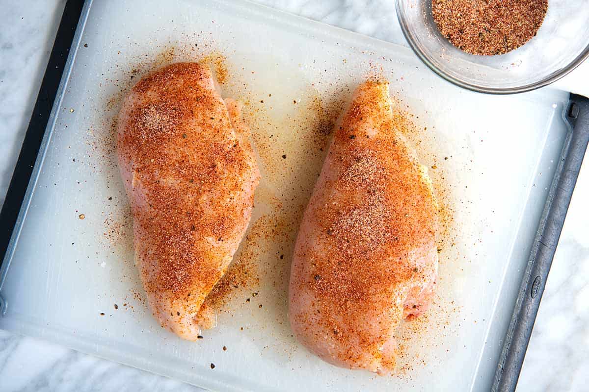 Seasoning the chicken breasts