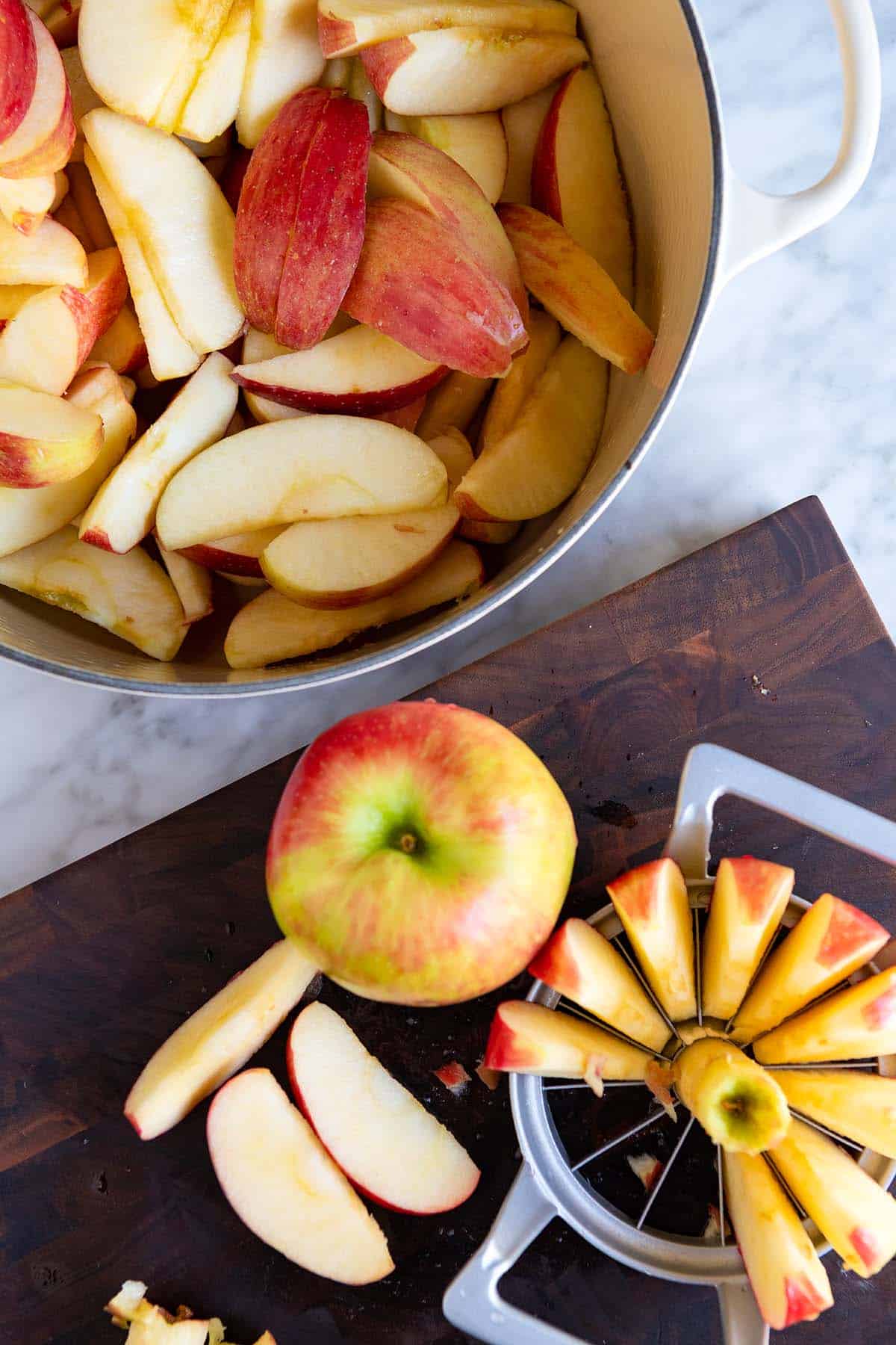 Step shot showing apples cut into wedges ready for making applesauce.