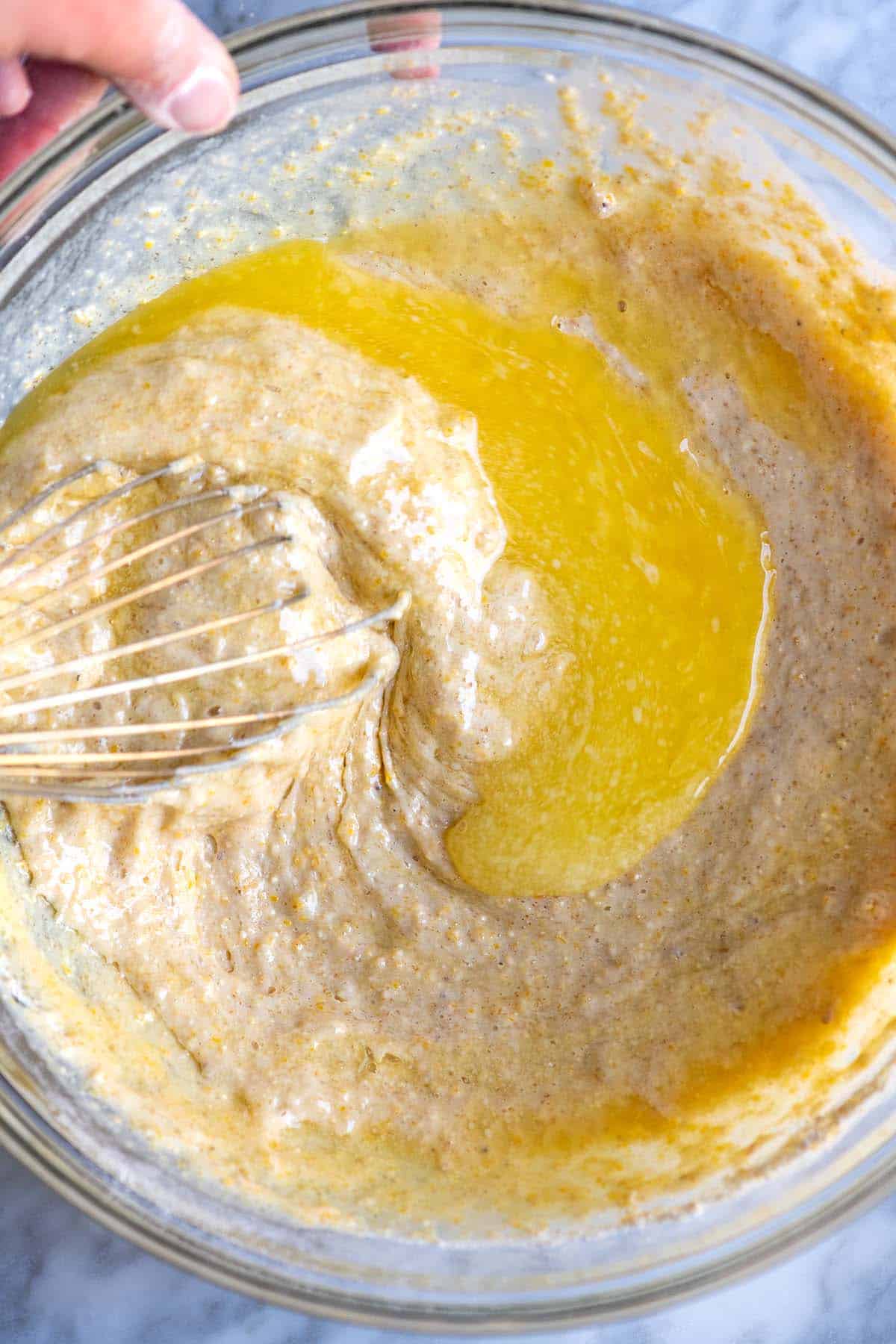 Adding melted butter to the cornbread batter
