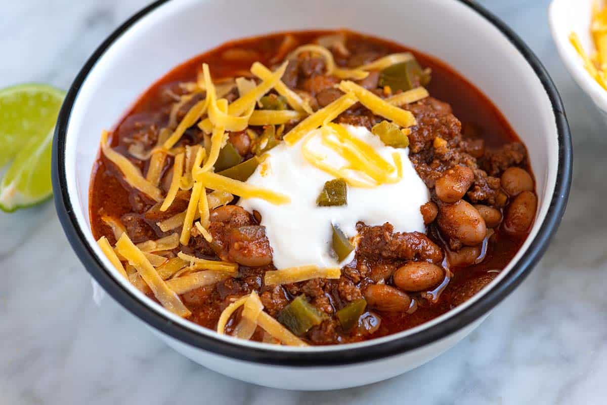 Bowl of homemade classic chili with sour cream and cheese