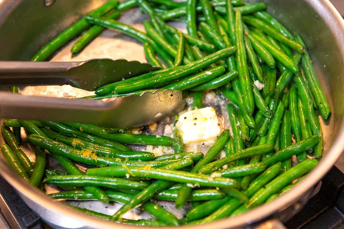 Adding garlic and butter to sautéed green beans