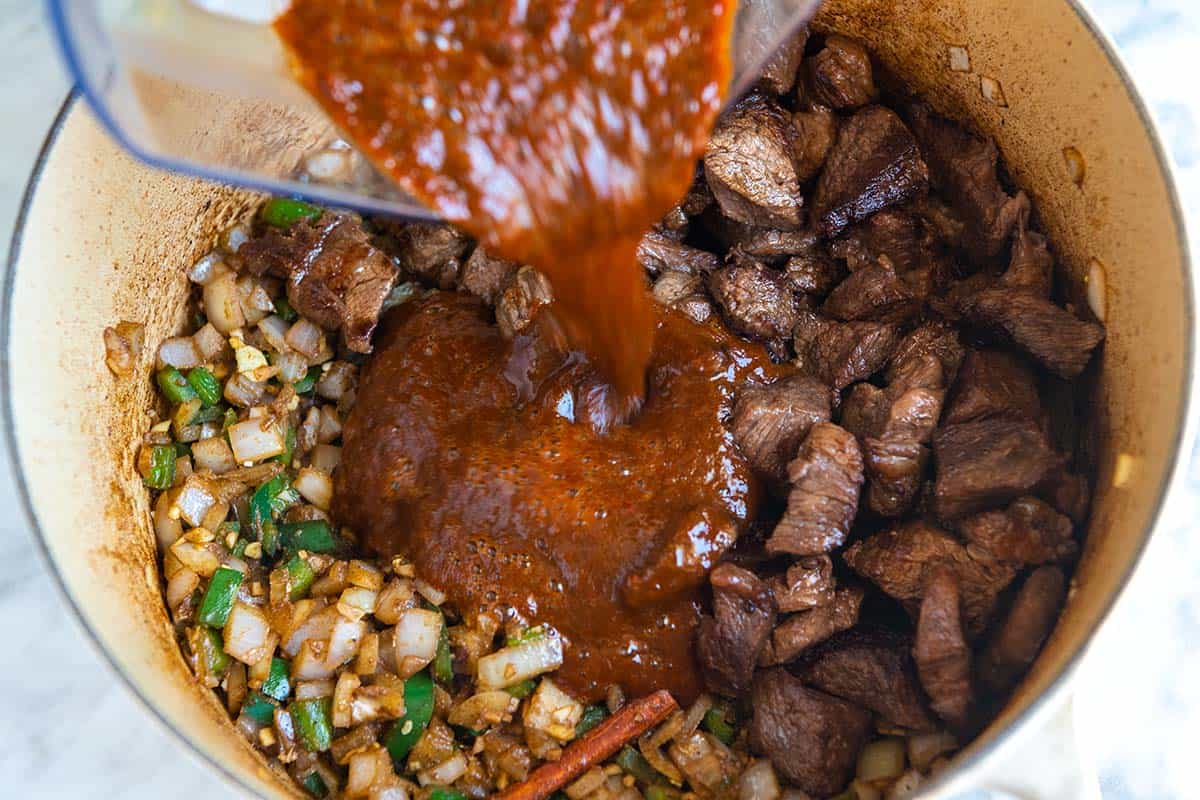 How to Make Texas Chili: Adding all the chili ingredients to the pot
