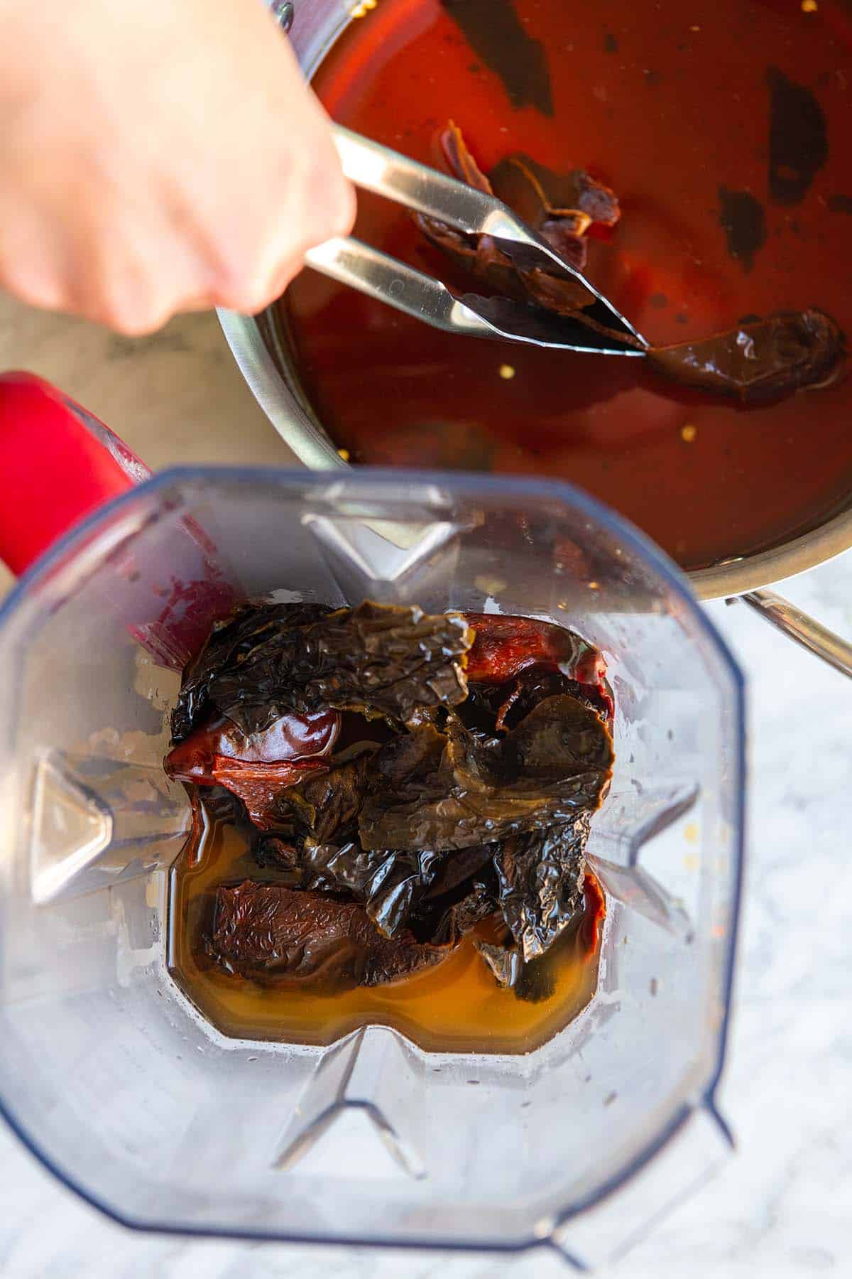 How to Make Texas Chili: Blending softened dried chile peppers into a chili paste