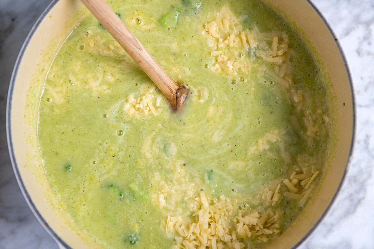 How to Make Broccoli Cheddar Soup: Stirring cheddar cheese into broccoli soup
