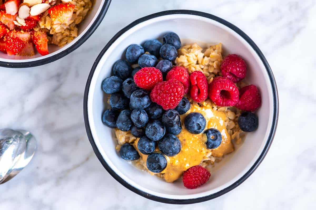 Bowl of oatmeal with blueberries and peanut butter.