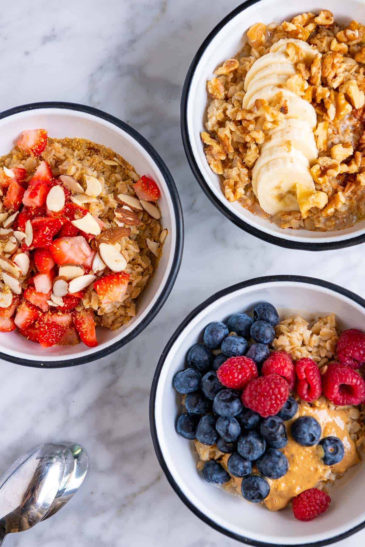 Oatmeal with different toppings (banana walnut, berries and peanut butter, & strawberries with flax meal)