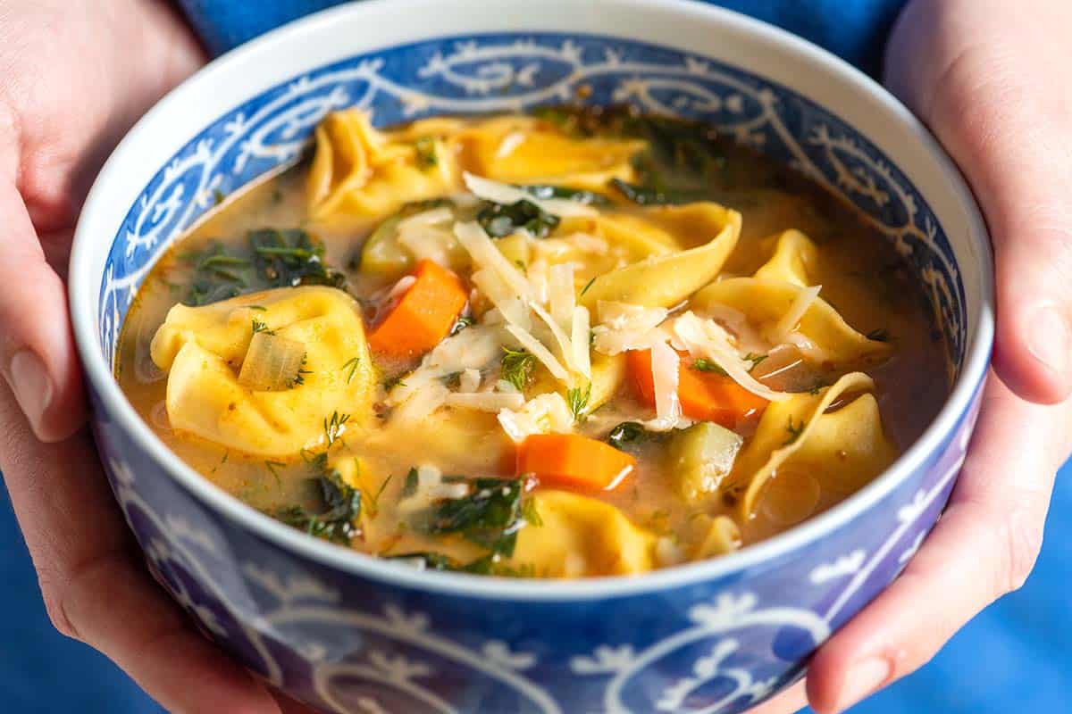 a bowl of Tortellini Soup with vegetables 