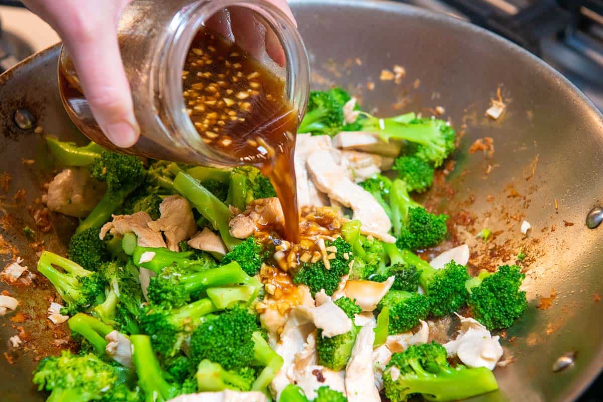 Adding the stir fry sauce to our chicken stir fry