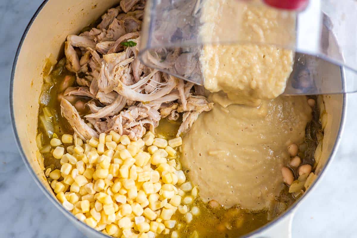 Making white chicken chili with corn, shredded chicken and pureed white beans.