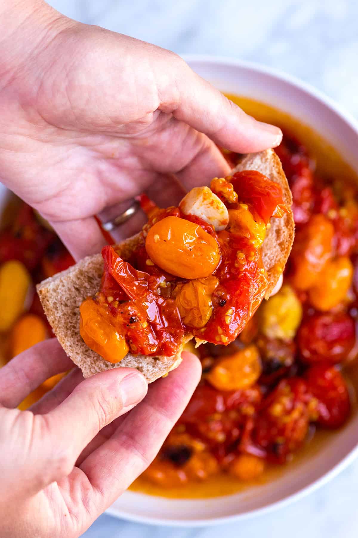 Roasted tomatoes spread onto a slice of bread